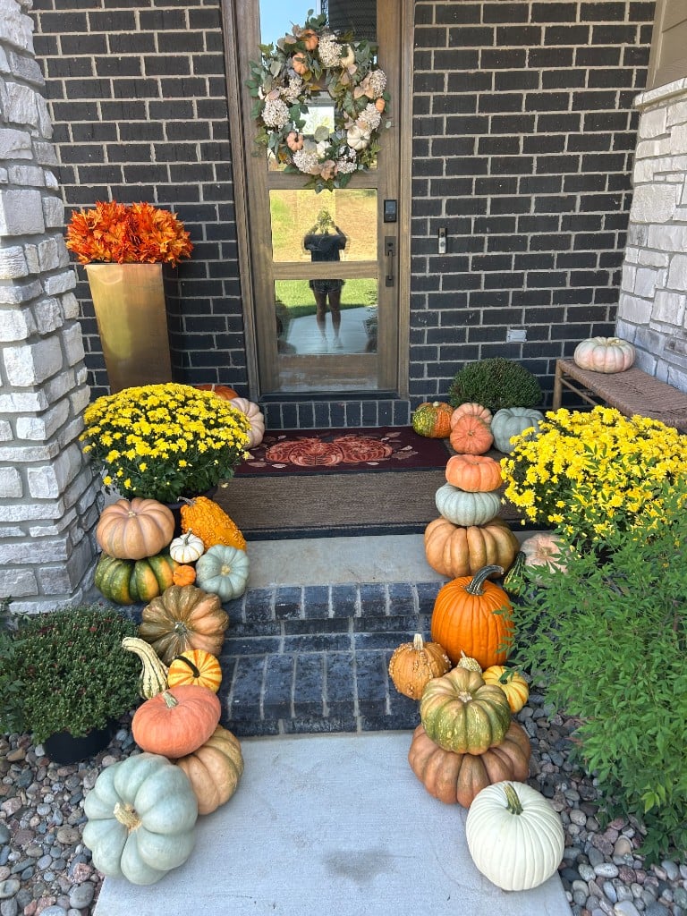 Charcoal brick steps overflowing with pumpkins and yellow mums